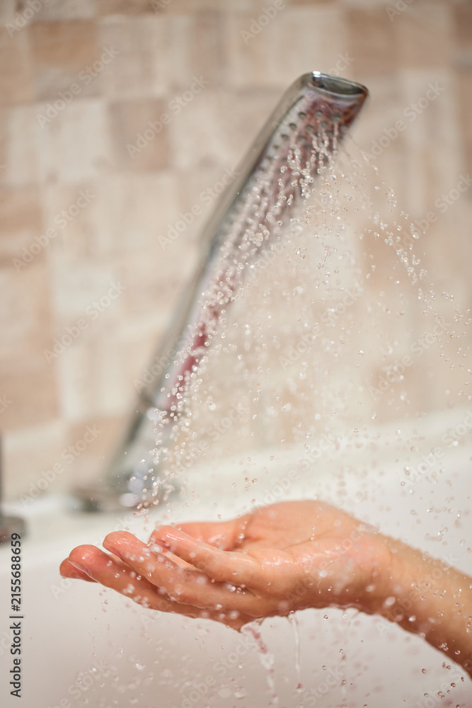 Fototapeta premium Hand catching fresh water from shower