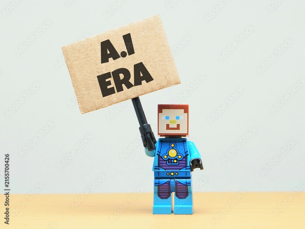 Obraz premium Indonesia - May 30, 2026 : Mini toy of action figure at table with blur background. Miniature photography concept design. Minifigure of Robot character hold Artificial Intelligence era text at poster.