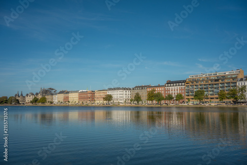 Scenic City Skyline and Architectural Facades Reflected on Lake Water