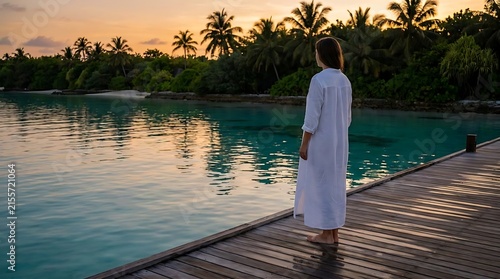 Woman in white dress standing on tropical dock