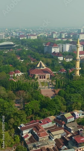 Aerial Yogyakarta mosque with tall minaret amid lush city greenery