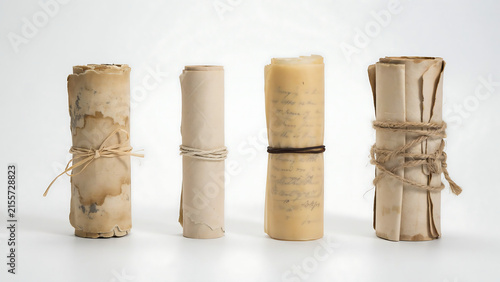 Four vintage paper scrolls tied with twine isolated on white background