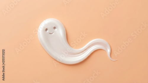 White cream smear shaped like a cute ghost with a smiling face on a soft peach background for cosmetic skincare product presentation and beauty