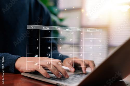 Digital calendar planning concept showing a professional working on a laptop, representing scheduling, time management, productivity, appointments, deadlines, organization, and business planning.
