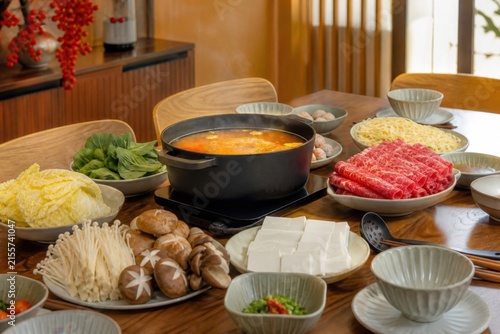 Lunar New Year reunion hot pot table with vegetables, tofu, noodles and reusable bowls for respectful cultural, food and gifting campaigns