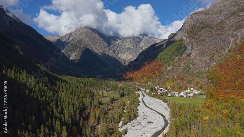 Les Borels village at the entrance of Ecrins National Park. Aerial autumn view in Champoleon Valley with Drac Blanc river. Champsaur, Hautes-Alpes, Alps, France
