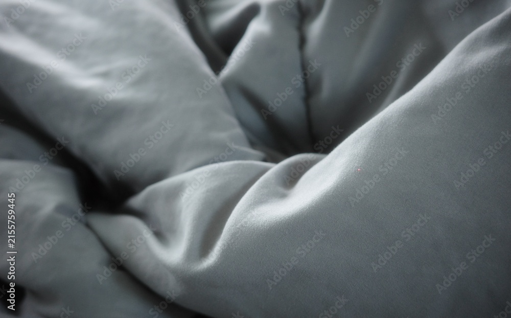 Naklejka premium The dark gray quilted fabric surface is wrinkled