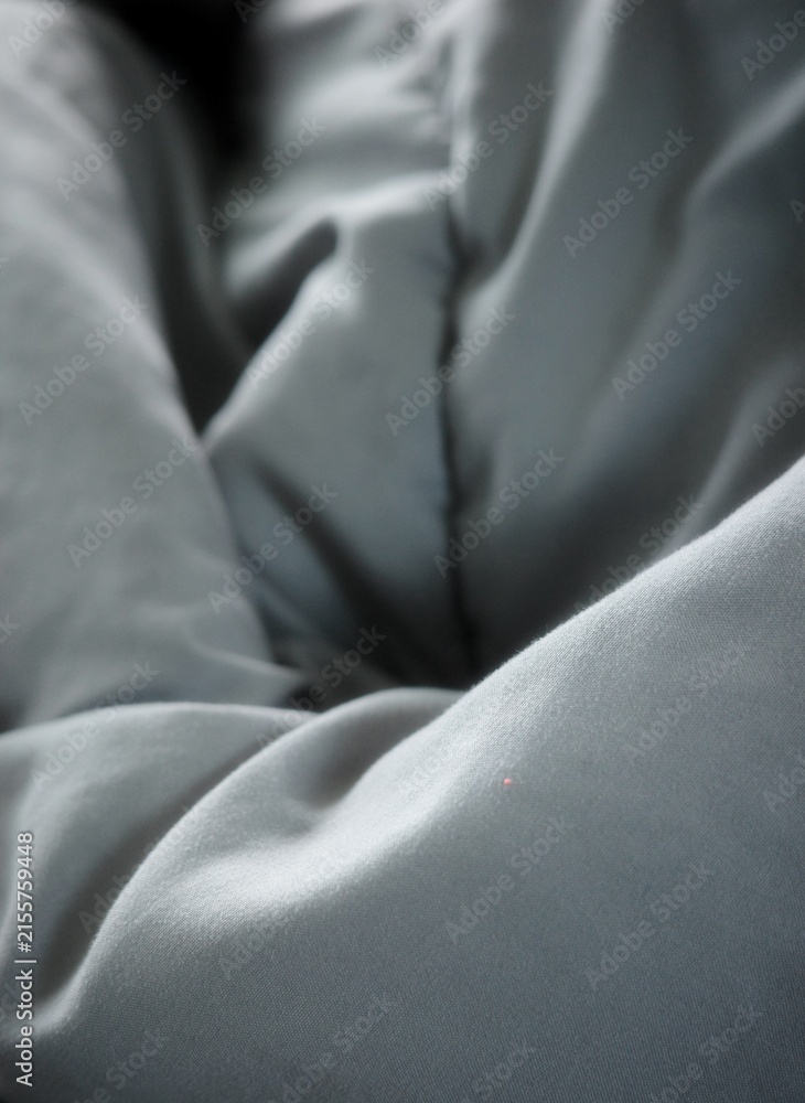 Naklejka premium The dark gray quilted fabric surface is wrinkled