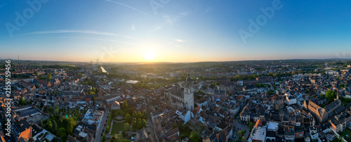 Halle, Vlaams Brabant, Belgium, 27th of April, 2025, A stunning panoramic view showcasing a vibrant cityscape at sunset, featuring beautiful buildings and lush green spaces