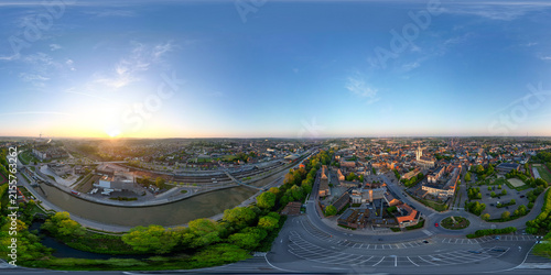 Halle, Vlaams Brabant, Belgium, 27th of April, 2025, A stunning aerial view of a vibrant city at sunrise, highlighting the beauty of urban life and nature
