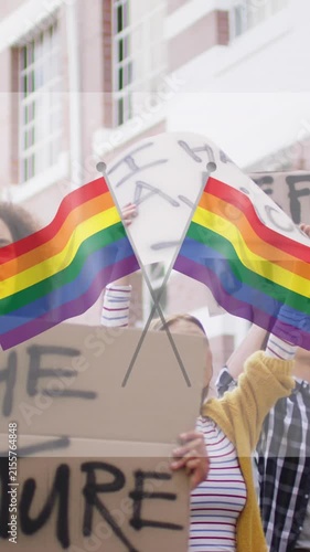 Animation of rainbow flags over diverse protesters with banners