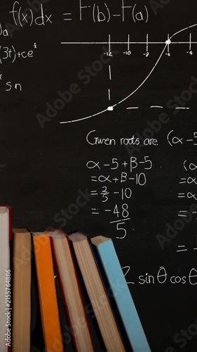 Pile of books and mathematical equations and graphs