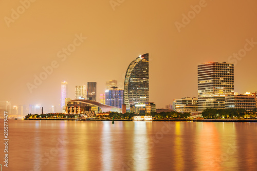 Modern urban architecture, road traffic, and Huangpu River night view in Lujiazui, Pudong, Shanghai, China	