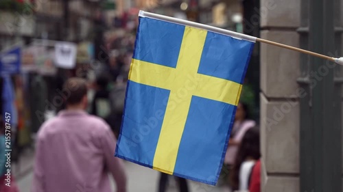 Stockholm Sweden with Swedish flag and people walking