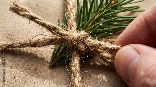 Macro hemp rope and pine sprig on gift