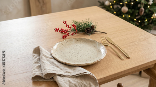 Minimalist Japandi Christmas dining table setting with empty ceramic plate.
