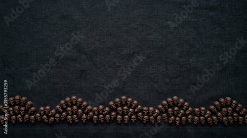 Flat lay dark chocolate skulls border with top copyspace