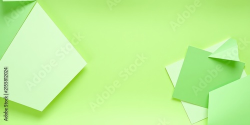 Abstract Background with Geometric Shapes of Green Paper on a Light Green Surface