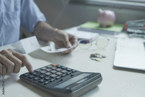 High-angle focus on financial planning, personal budgeting tax calculation and small business expense tracking at a home office workspace.