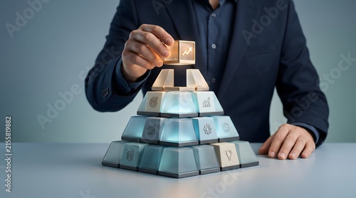 Businessman hand inserting glowing golden arrow cube into glass pyramid puzzle. Concept of corporate business solution and leadership strategy.
