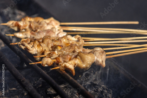 Satay, a famous Indonesian dish, with skewered meat grilled over hot charcoal