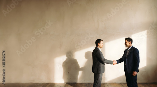 business partnership handshake in warm office with copy space