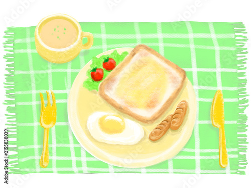 緑のランチョンマットの上にトーストと目玉焼きとウインナー・サラダ・スープの朝ごはんが乗ったイラスト