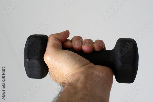 Fotografía Hand Holding a Black Dumbbell for Strength Training and Fitness