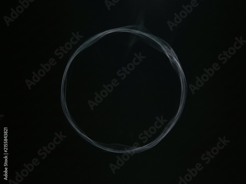 A delicate, thin, and abstract ring formation made of extremely soft white vapor
