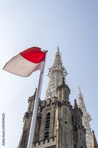 The Cathedral of Our Lady of the Assumption stands beside the Indonesian flag,