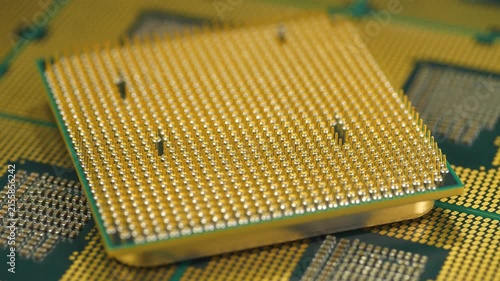 PC CPU close up highlighting golden micro pin arrangement for high speed computing, zoom-out video