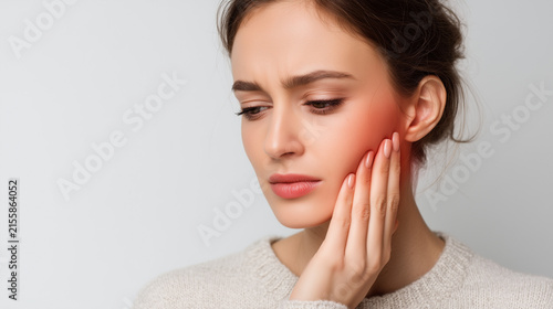 Woman touching her jaw while experiencing facial discomfort, with a highlighted pain area, representing TMJ problems, dental pain, oral health and medical care.