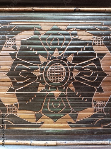 Photography Traditional bamboo craft featuring intricate decorative geometric and floral carvings on bamboo slats