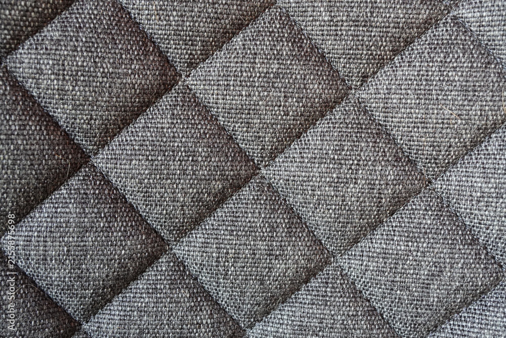 Naklejka premium Close up of gray quilted fabric texture with diamond pattern