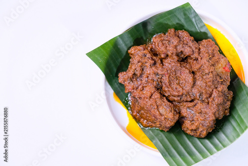 Rendang is traditional food from West Sumatra, Indonesia. It is made from beef stew and coconut milk with various herbs and spice. Isolated on white background
