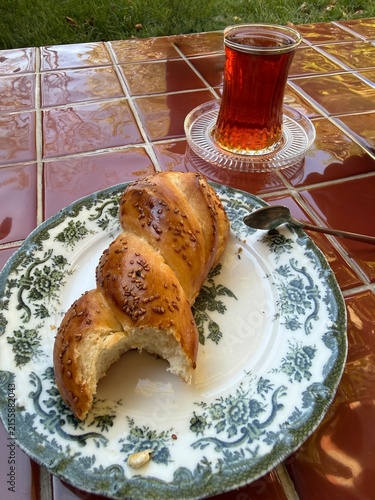 Traditional Turkish Breakfast Scene with Freshly Baked Sesame Pastry Achma and Hot Black Tea