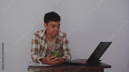 Engaged Young Man Interacting with Technology: A Modern Encounter at Home Office