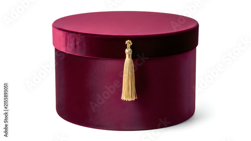 Round maroon velvet gift box with a decorative gold tassel isolated on white background