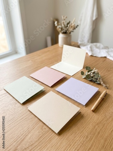 Aesthetic Flat Lay of Blank Greeting Cards and Dried Flowers on a Wooden Table.