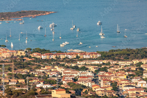 aerial closeup of porto san paolo, sardinia, town center and bay with jetty, tourist attraction, holidays, vacation