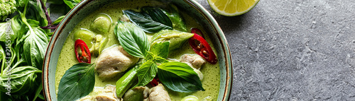 A fresh bowl of green curry with vegetables and herbs, perfect for a delicious meal.
