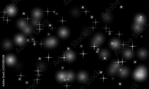 Shimmering white star flares and bokeh lights on black background