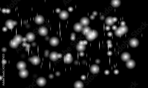 Glowing white bokeh circles floating on black background