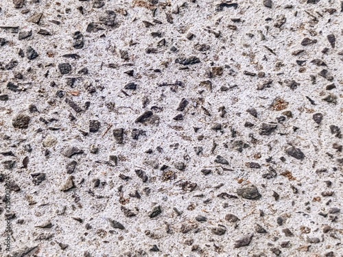 Fotografie Exposed aggregate concrete texture background with dark crushed stones