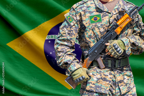 Fotografía Brazil flag with soldier holding assault rifle