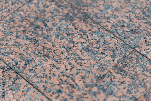 Vibrant texture of polished granite showcasing nature's artistry in a serene outdoor setting during bright daylight