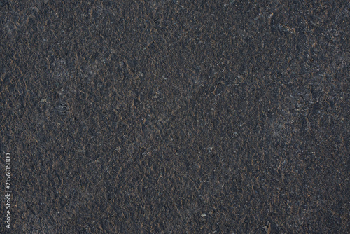Dark gray asphalt texture with a rough granular surface, suitable for abstract backgrounds, road , and industrial designs