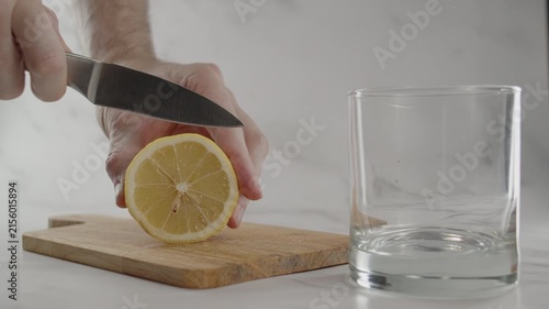 Slicing lemon and putting it in glass. Original sound. 24fps. Prores 422HQ