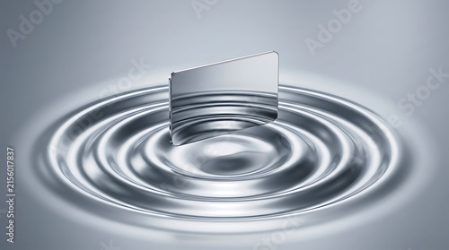 Metallic silver payment card hovering over concentric circles