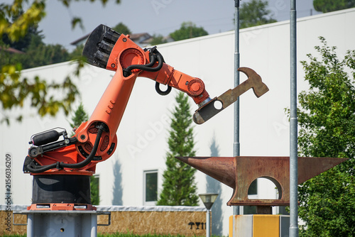 Industrial robot sculpture symbolizing automation and the use of robotics for heavy-duty work.